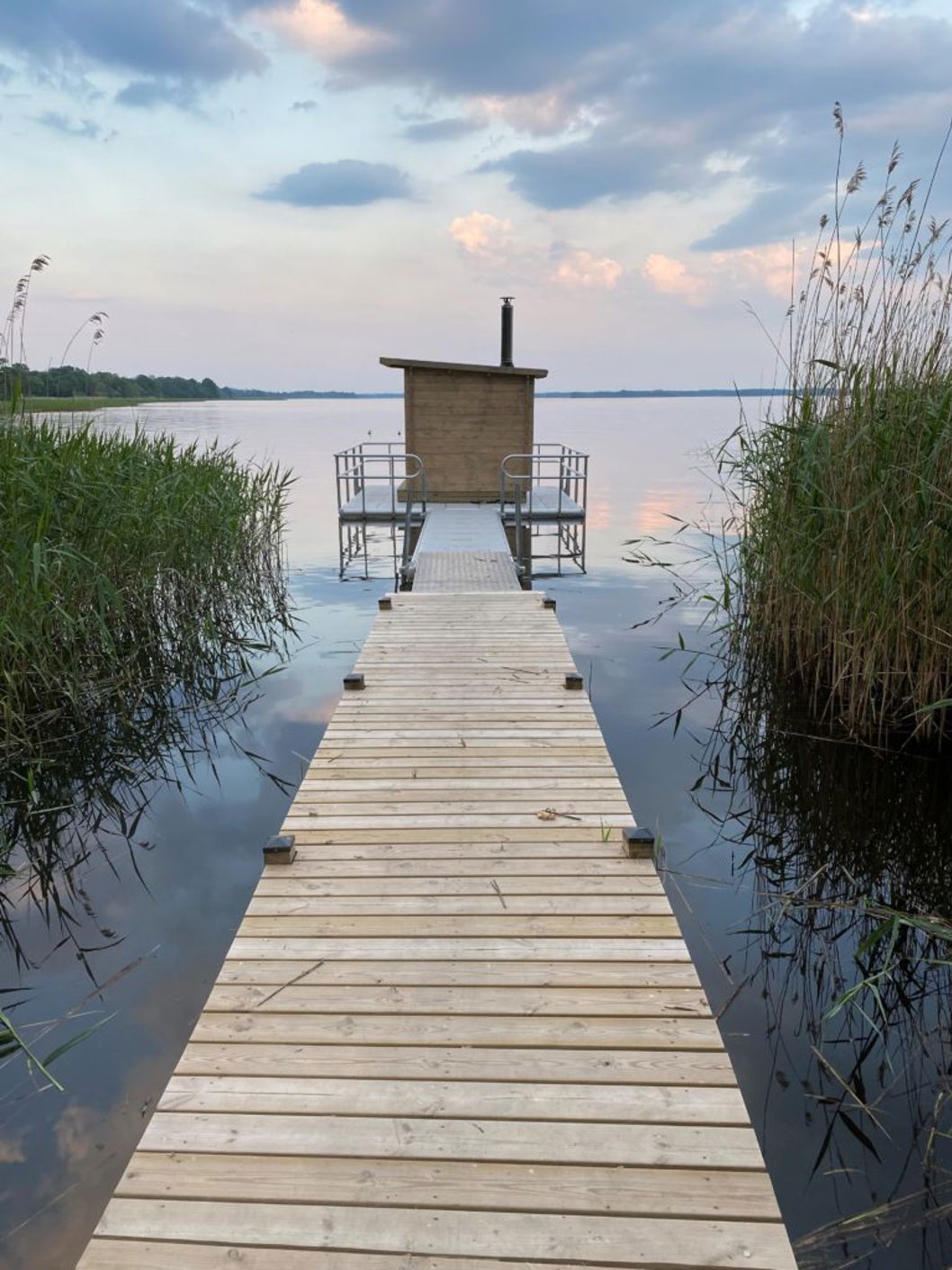 EasyFloat Saunafloss an einem Steg, bei dem die Geländer auf dem EasyFloat-Steg montiert sind, an einem Binnensee in Norrköping